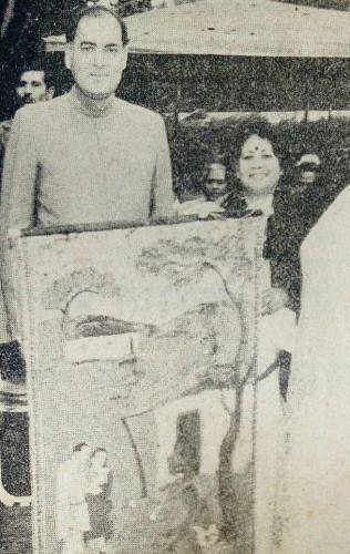 Former Prime Minister of India, Shri Rajiv Gandhi holding a batik wall hanging made by Shri Satish Joshi depicting Shri Rajiv Gandhi's visit to Jhabua, Madhya Pradesh.